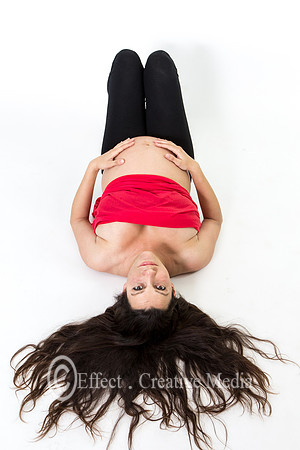 young beautiful pregnant woman,lying with her hand on here belly