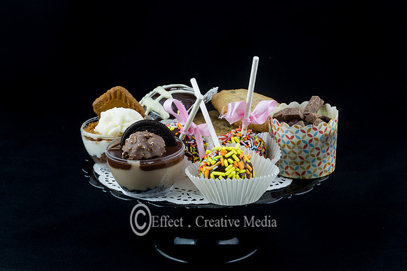 vraity of  chocolate cakes and cookies on a plat, black backgrou