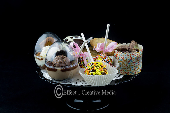 vraity of  chocolate cakes and cookies on a plat, black backgrou