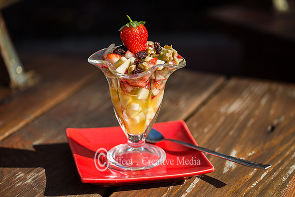 Bowl of fresh fruit salad with strwberry on top