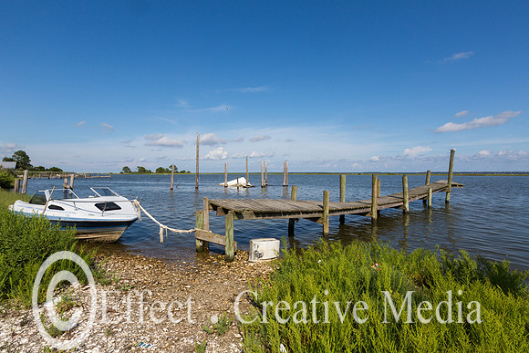 a boat tied wigh a rope to an old pier near ST George Island Flo